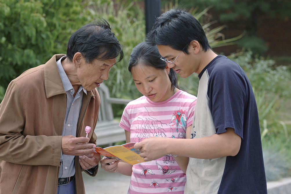 A family looking at a brochure.